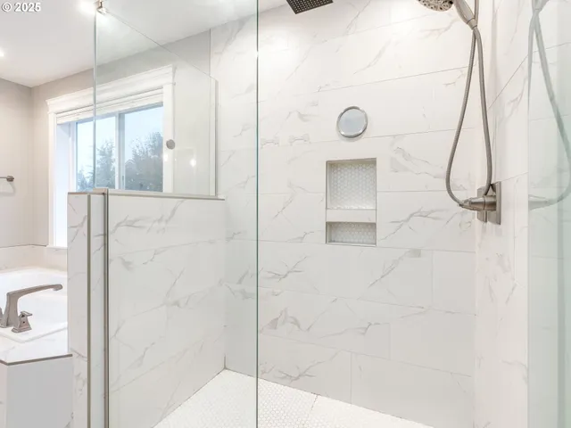 a bathroom with a shower and a mirror
