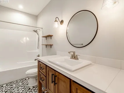 a bathroom with a sink a toilet and a mirror