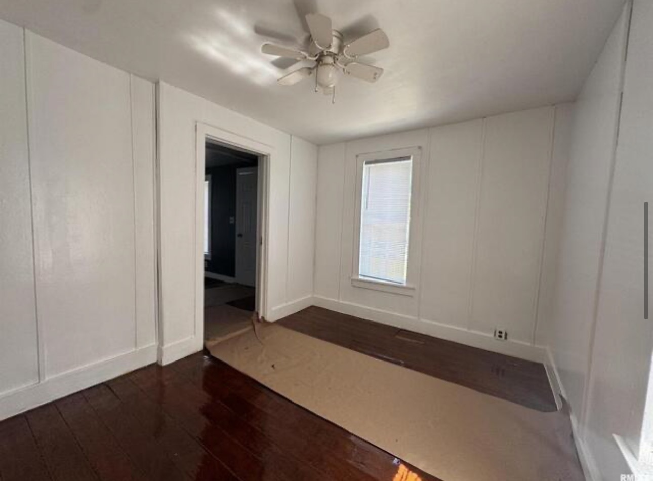 302 Coeburg Street Rio, IL 61472 - Photo 11 of 22 an empty room with wooden floor and windows