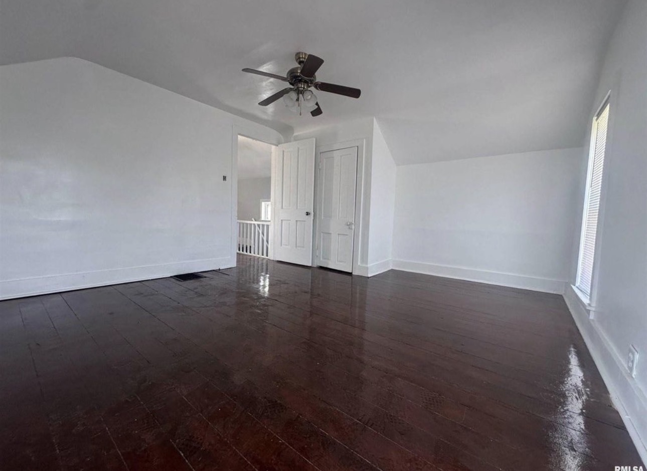 302 Coeburg Street Rio, IL 61472 - Photo 17 of 22 an empty room with wooden floor fan and windows