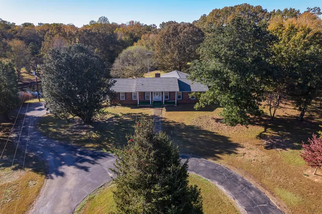 an aerial view of a house with a yard and lake view