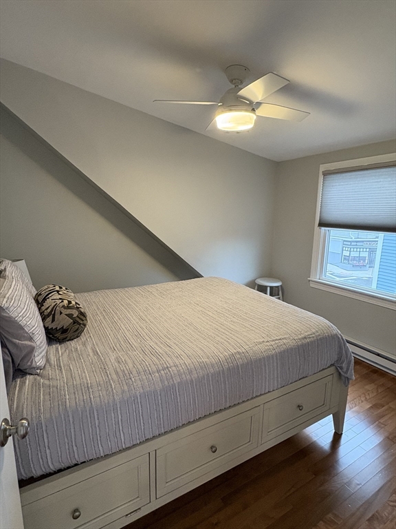 97 Washington Street, Unit 3 Gloucester, MA 01930 - Photo 11 of 15 a bedroom with a bed and a night stand