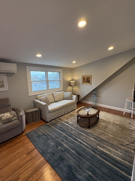 97 Washington Street, Unit 3 Gloucester, MA 01930 - Photo 12 of 15 a living room with furniture and a window