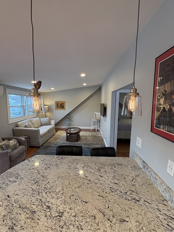 97 Washington Street, Unit 3 Gloucester, MA 01930 - Photo 13 of 15 a living room with furniture and a chandelier