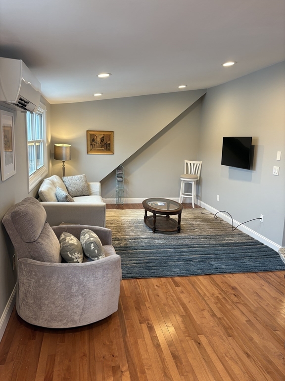 97 Washington Street, Unit 3 Gloucester, MA 01930 - Photo 2 of 15 a living room with furniture and a flat screen tv