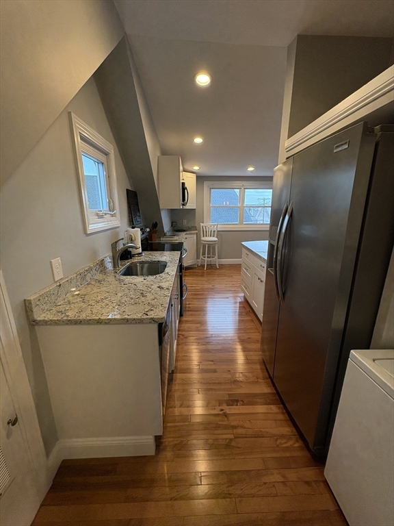 97 Washington Street, Unit 3 Gloucester, MA 01930 - Photo 4 of 15 a kitchen with stainless steel appliances granite countertop a refrigerator a sink and a stove