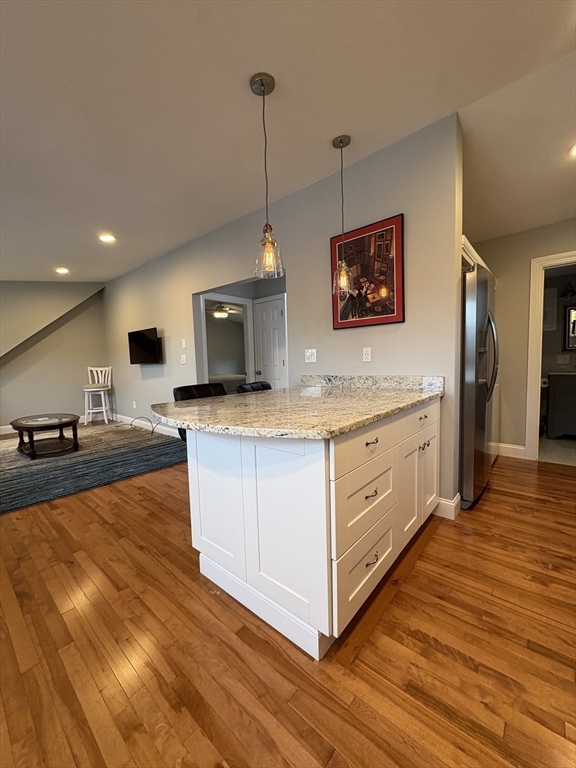 97 Washington Street, Unit 3 Gloucester, MA 01930 - Photo 8 of 15 a kitchen with stainless steel appliances granite countertop a stove a sink and a wooden floors