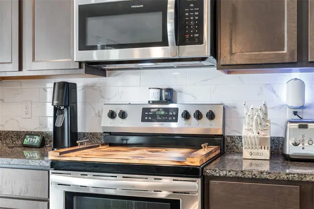 a stove top oven sitting inside of a kitchen