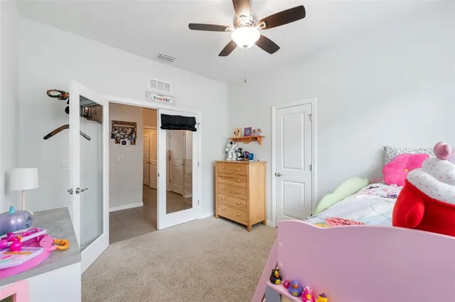 a bedroom with furniture and a chandelier