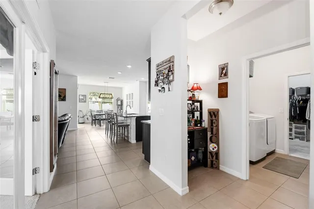 a view of a living room with furniture and a kitchen view