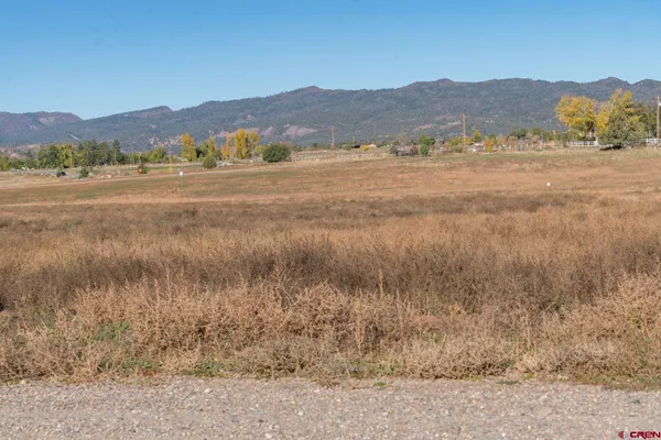 a view of mountain with sunset in background