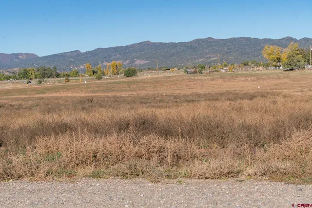 a view of mountain with sunset in background