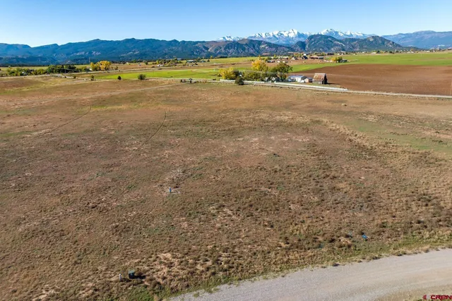 a view of an ocean with beach and city