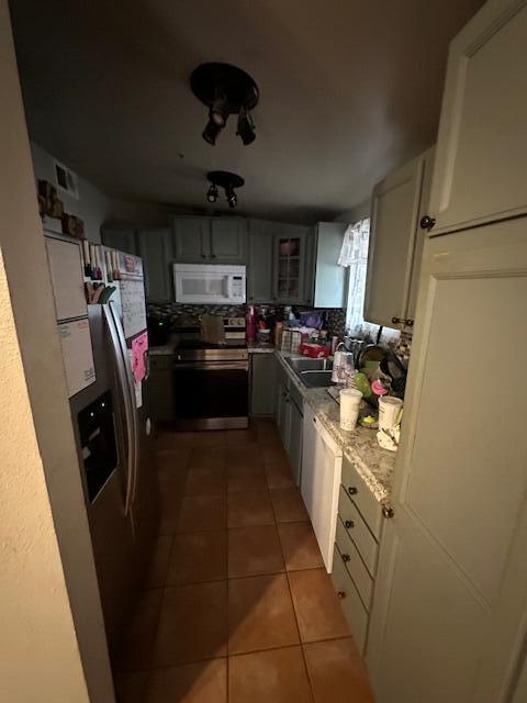 82615 4th Street Trona, CA 93562 - Photo 16 of 25 a kitchen with stainless steel appliances granite countertop a refrigerator a stove and a sink with wooden floor