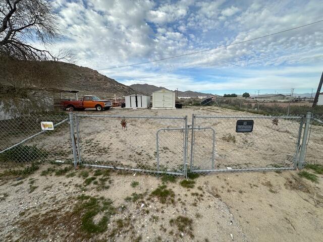 82615 4th Street Trona, CA 93562 - Photo 25 of 25 a view of a dry yard with wooden fence