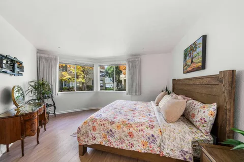 a bedroom with a bed and a couch