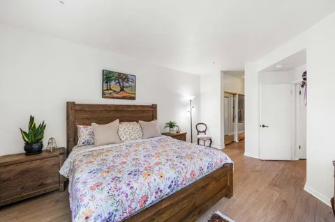 a bedroom with a bed and a potted plant