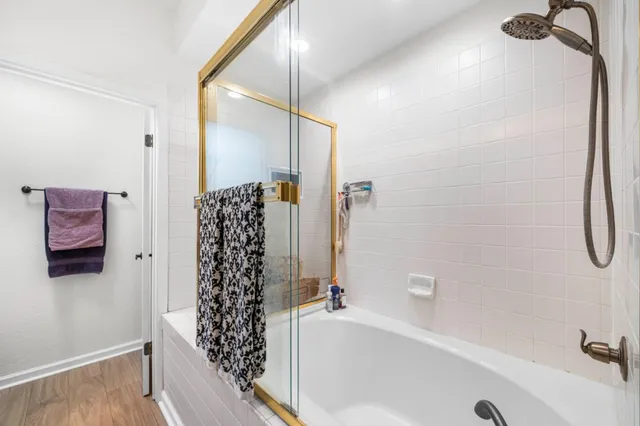 a bathroom with a bathtub and shower