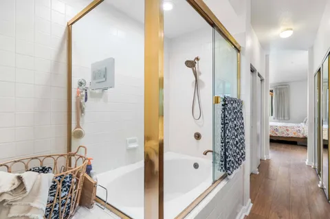 a bathroom with a bathtub and shower