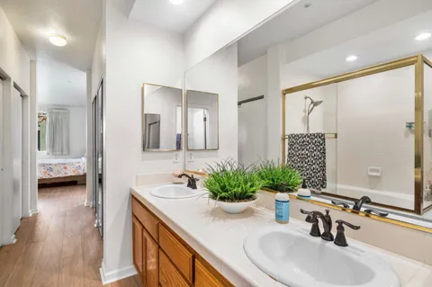 a bathroom with a double vanity sink and a mirror