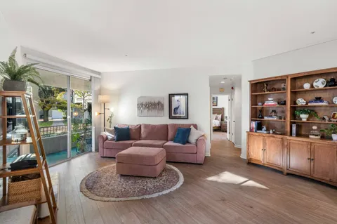 a living room with furniture and a book shelf