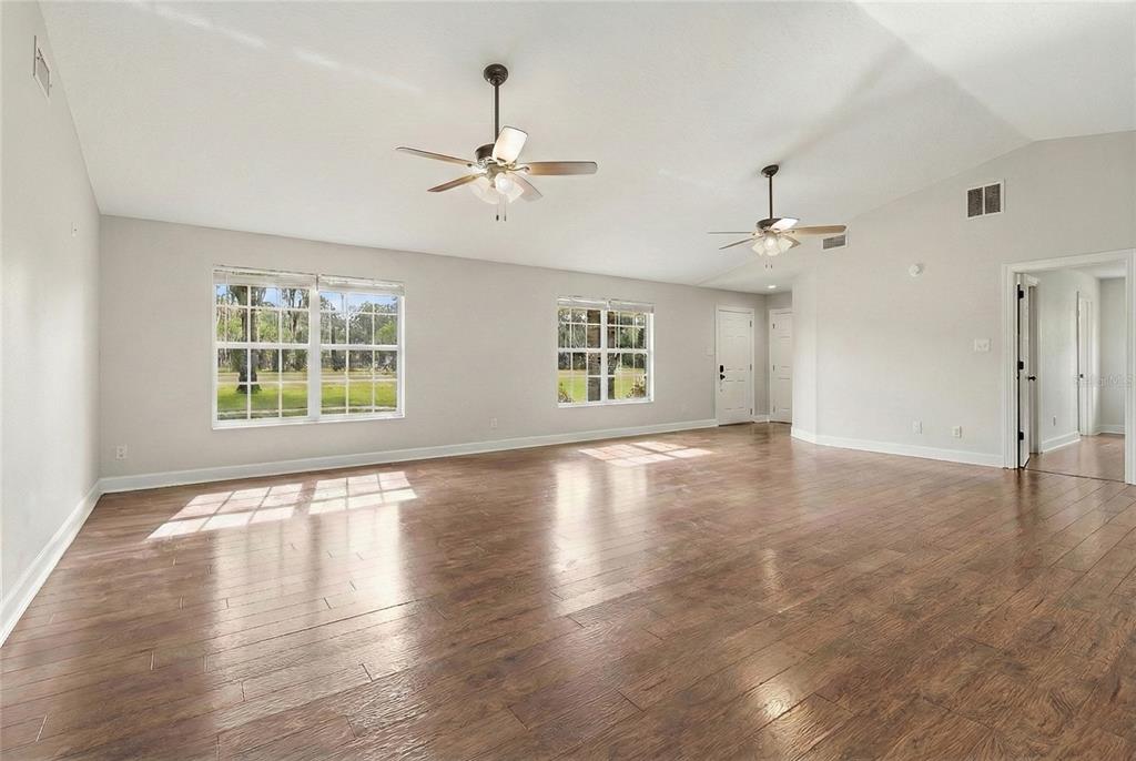 2331 D R Bryant Road Lakeland, FL 33810 - Photo 18 of 74 a view of an empty room with wooden floor and a window