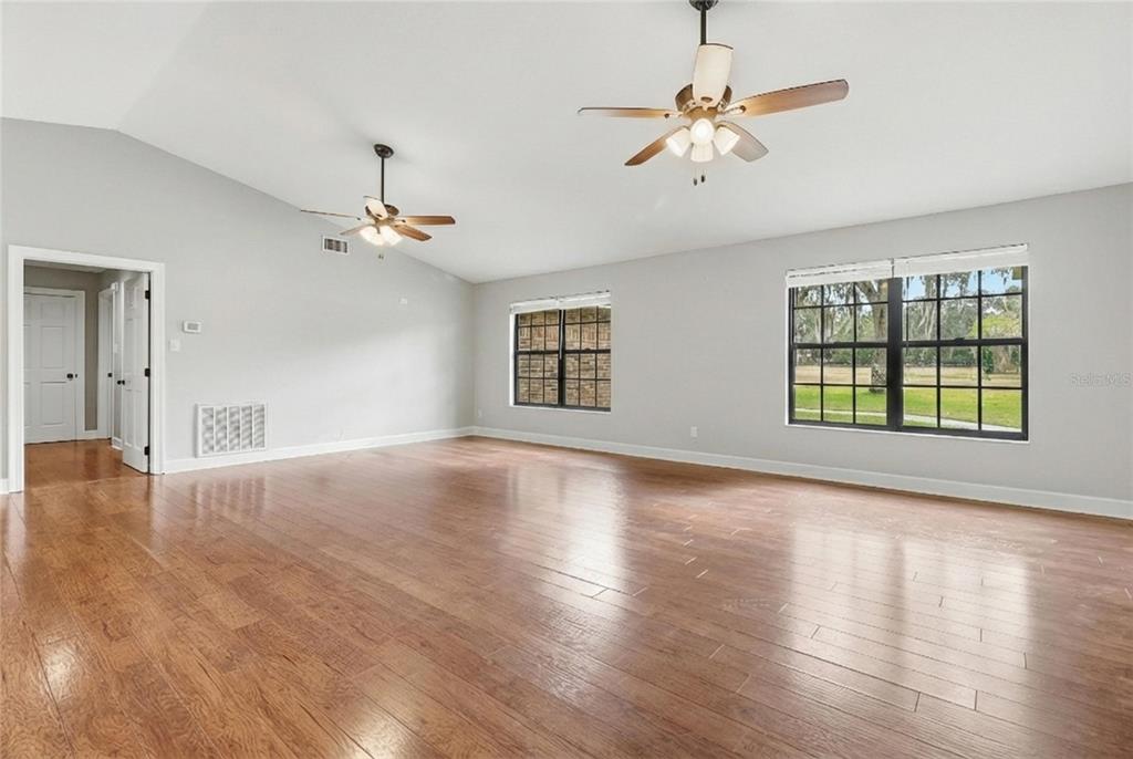 2331 D R Bryant Road Lakeland, FL 33810 - Photo 19 of 74 a view of an empty room with window and wooden floor