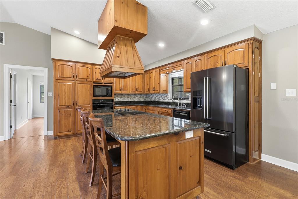 2331 D R Bryant Road Lakeland, FL 33810 - Photo 28 of 74 a kitchen with stainless steel appliances granite countertop a refrigerator a sink and a stove