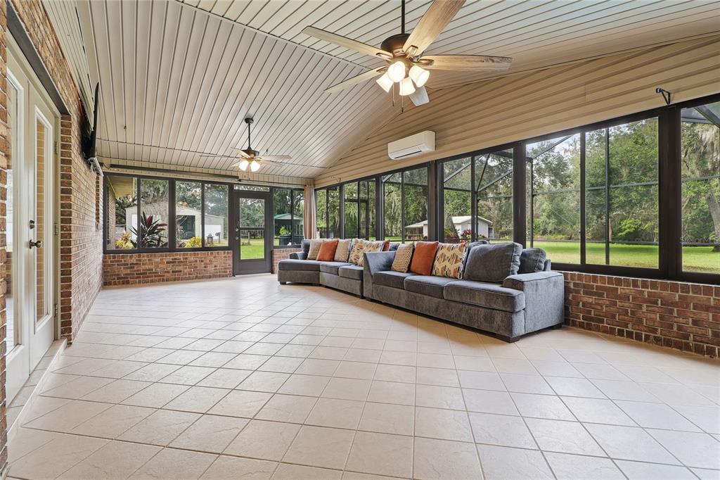 2331 D R Bryant Road Lakeland, FL 33810 - Photo 56 of 74 a living room with furniture and a floor to ceiling window