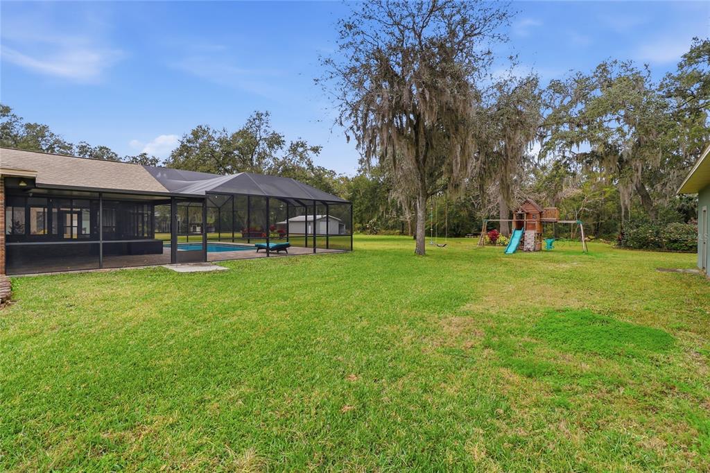 2331 D R Bryant Road Lakeland, FL 33810 - Photo 64 of 74 a backyard of a house with lots of green space and fountain