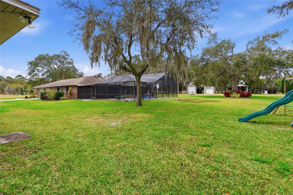 2331 D R Bryant Road Lakeland, FL 33810 - Photo 65 of 74 a view of a house with a big yard and palm trees
