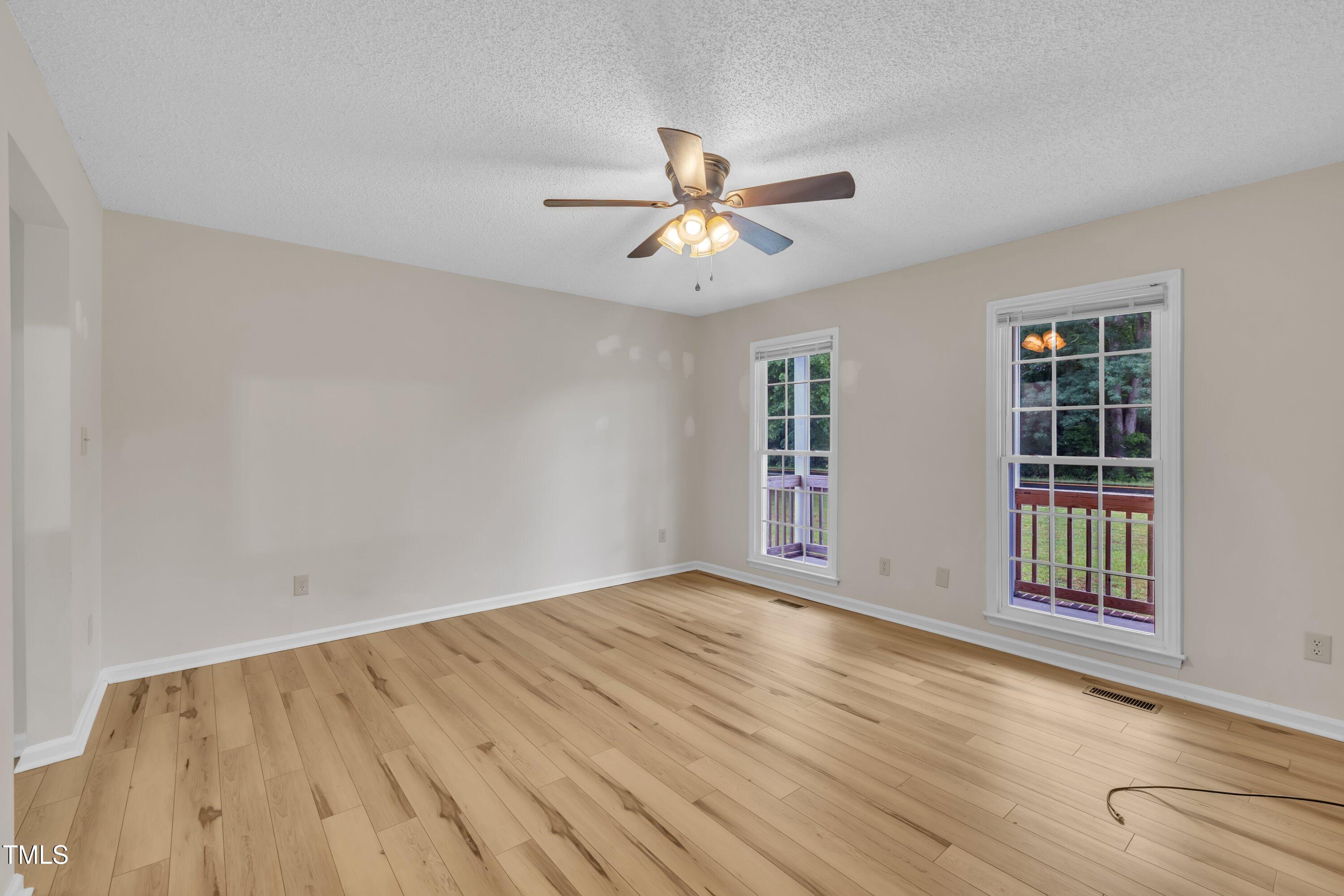 397 Meadow Road Kenly, NC 27542 - Photo 11 of 53 wooden floor in an empty room with a window