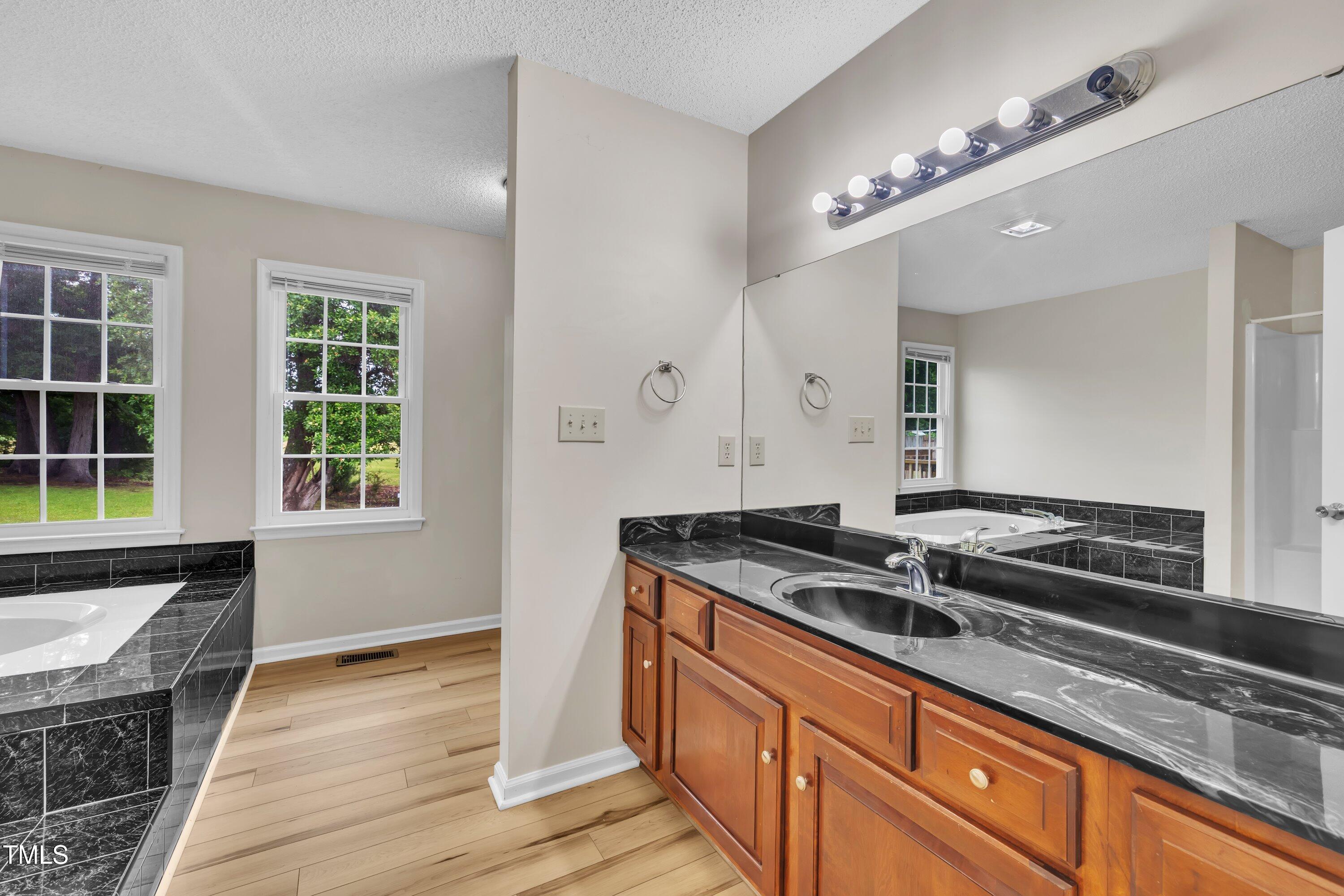 397 Meadow Road Kenly, NC 27542 - Photo 12 of 53 a kitchen with granite countertop a stove and a sink