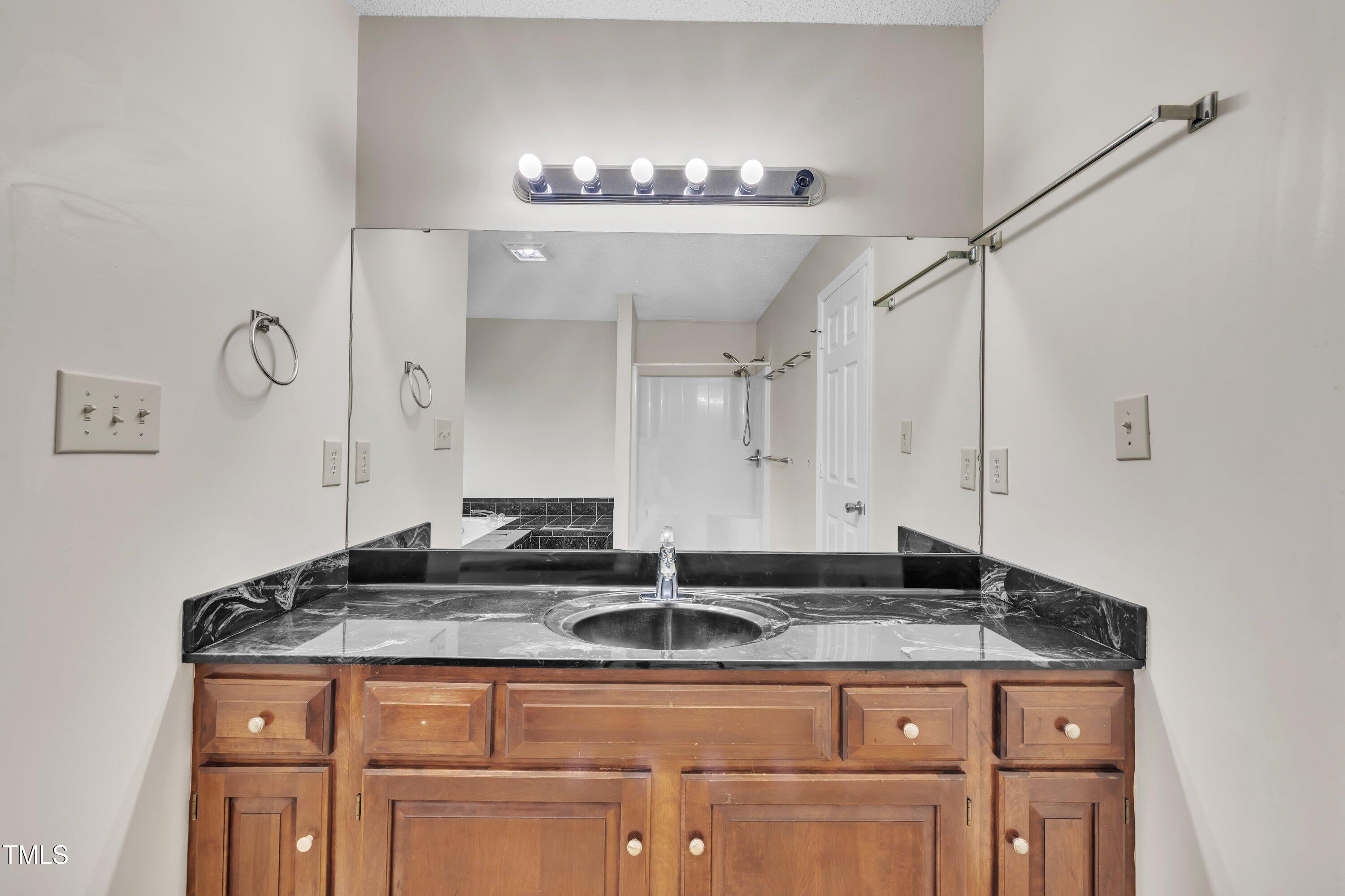 397 Meadow Road Kenly, NC 27542 - Photo 13 of 53 a bathroom with a granite countertop sink a mirror and cabinets