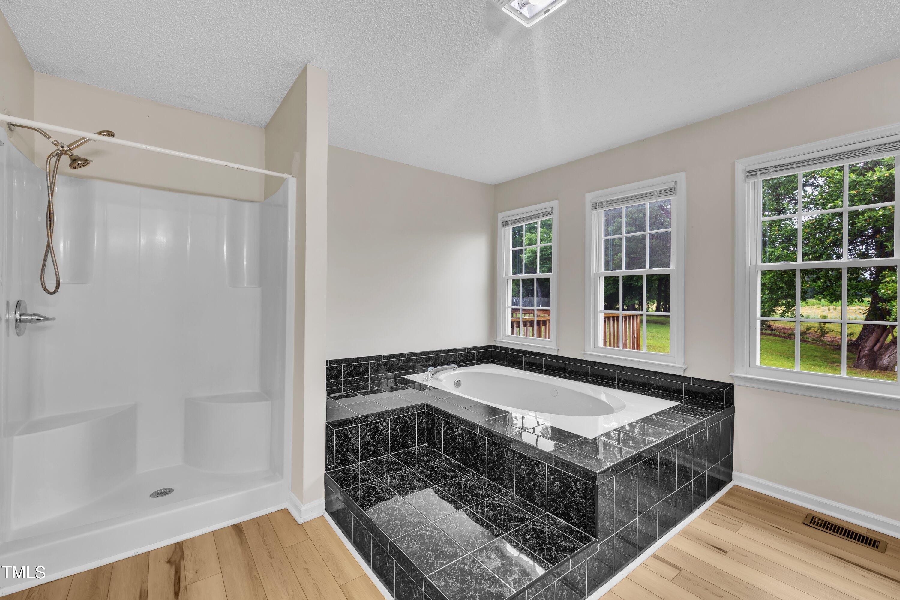 397 Meadow Road Kenly, NC 27542 - Photo 14 of 53 a spacious bathroom with a tub and shower