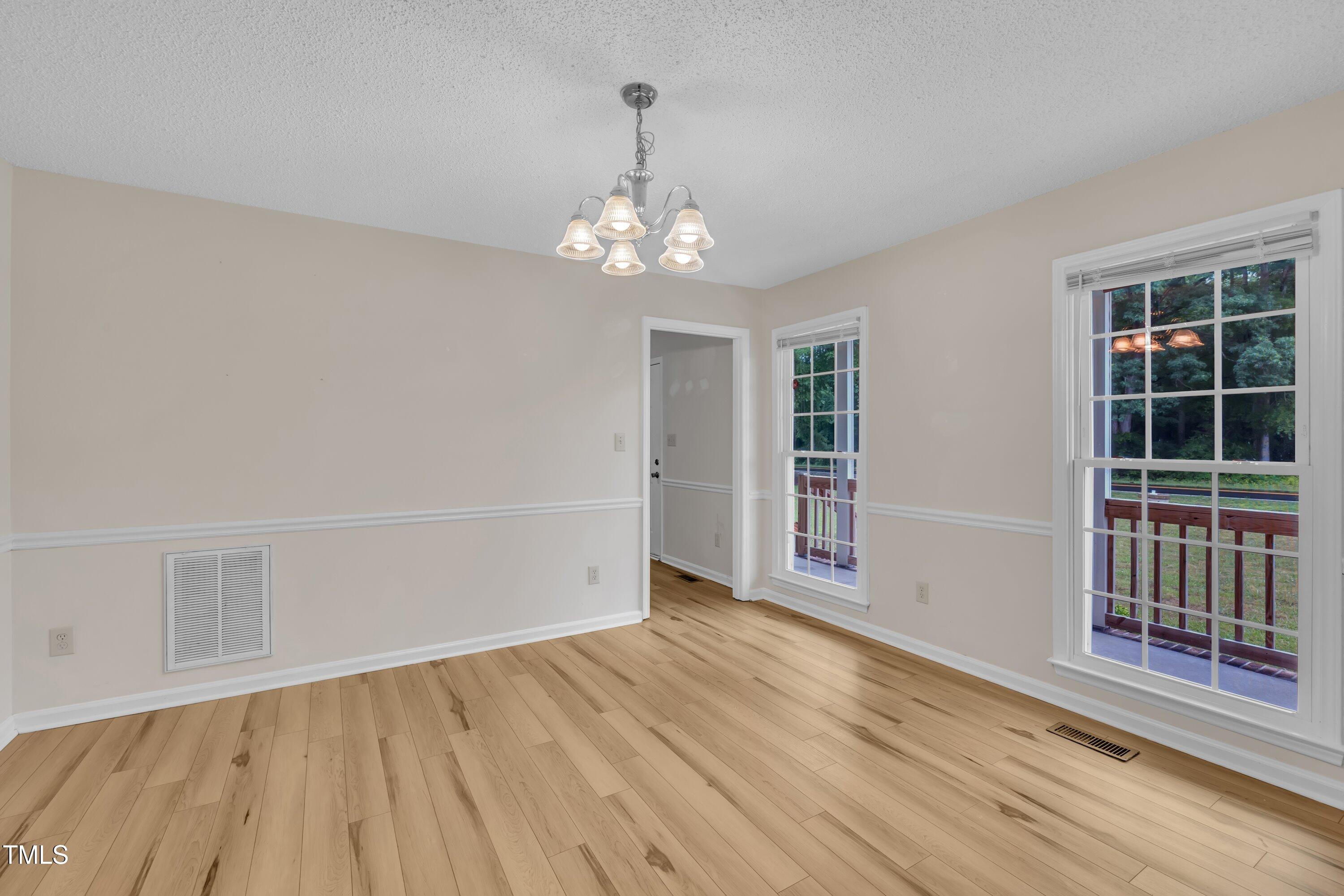 397 Meadow Road Kenly, NC 27542 - Photo 16 of 53 wooden floor in an empty room with a window