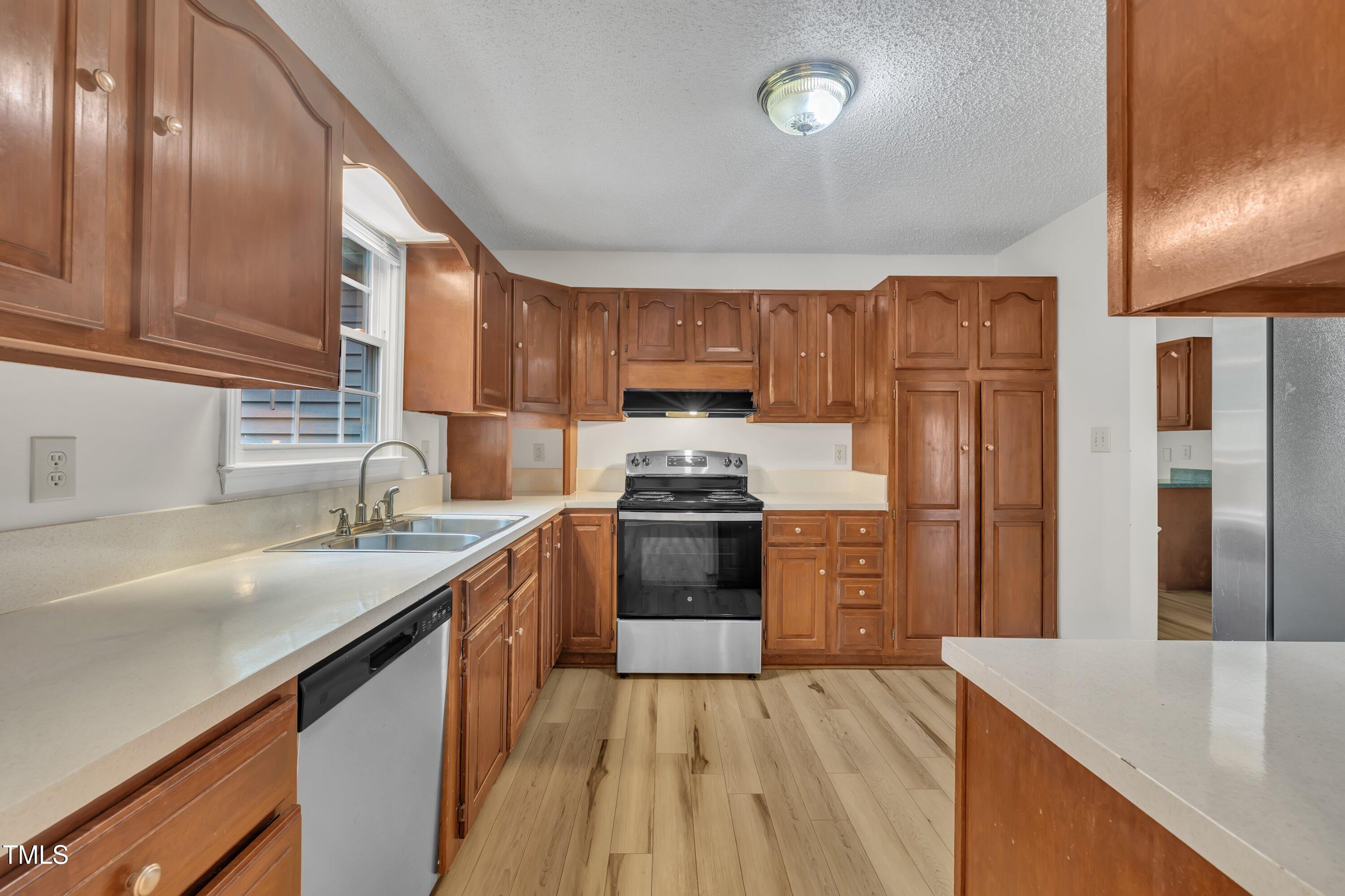 397 Meadow Road Kenly, NC 27542 - Photo 17 of 53 a kitchen with granite countertop a sink stove and refrigerator