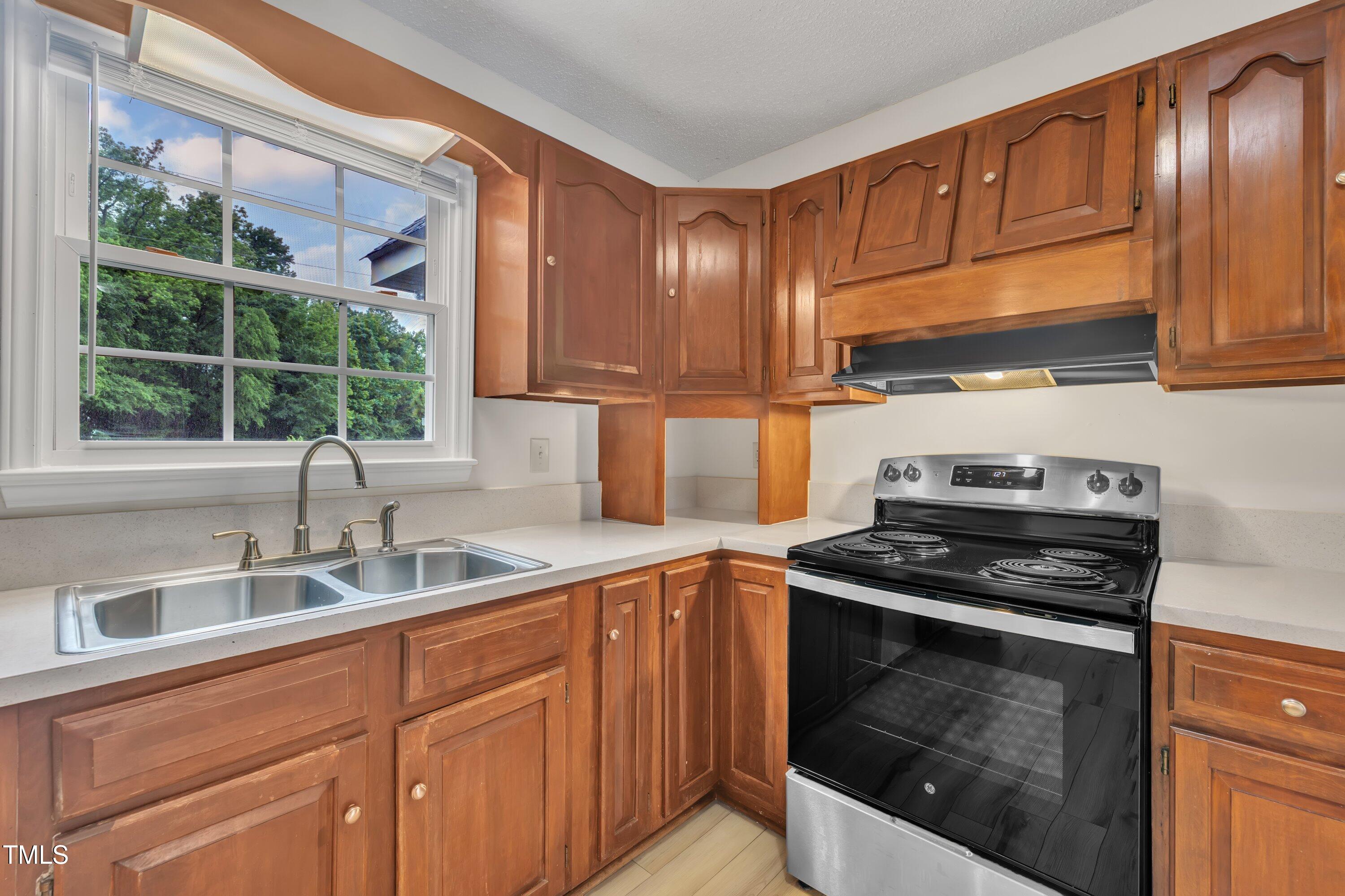 397 Meadow Road Kenly, NC 27542 - Photo 18 of 53 a kitchen with granite countertop a sink stainless steel appliances and cabinets