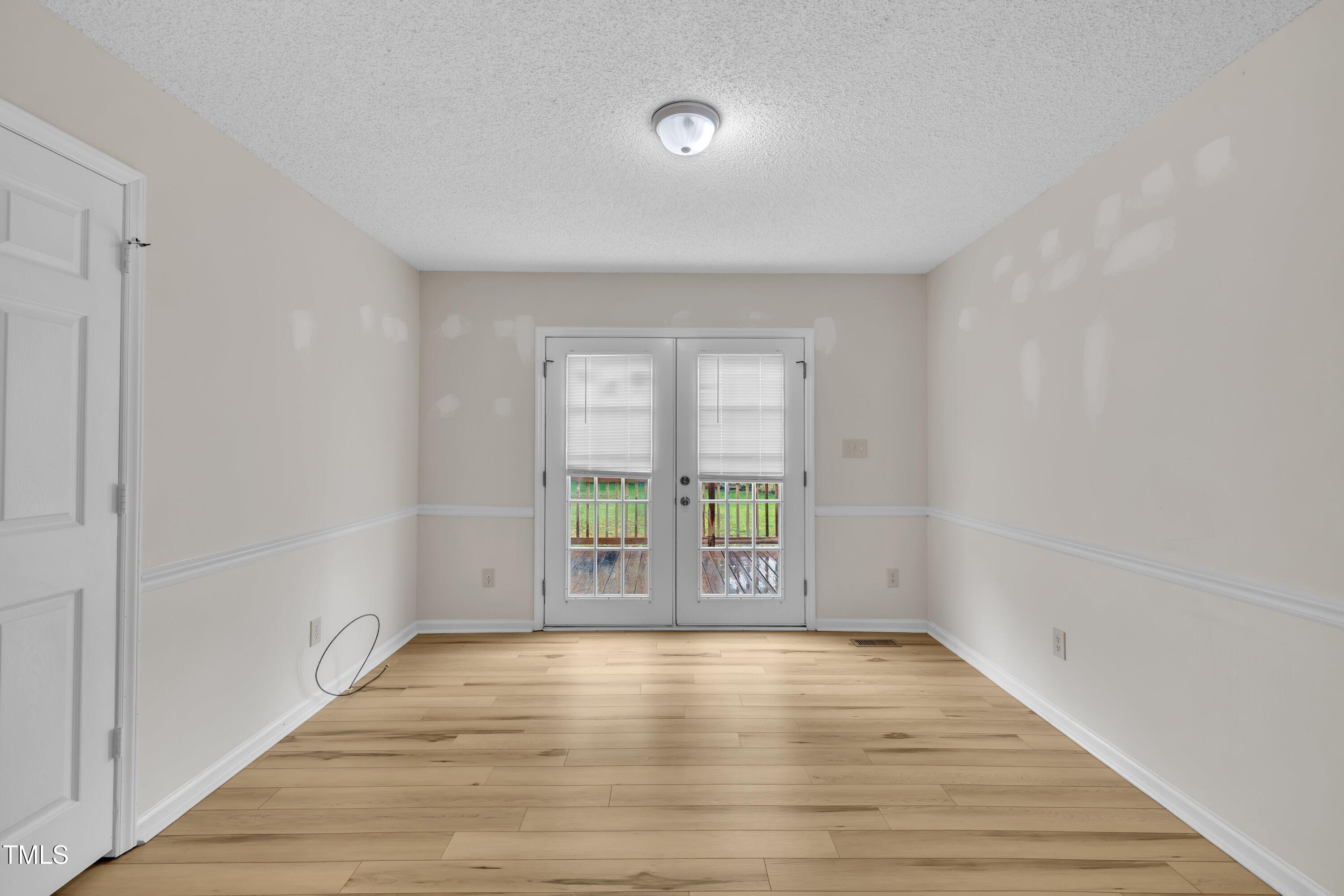 397 Meadow Road Kenly, NC 27542 - Photo 23 of 53 wooden floor in an empty room with a window