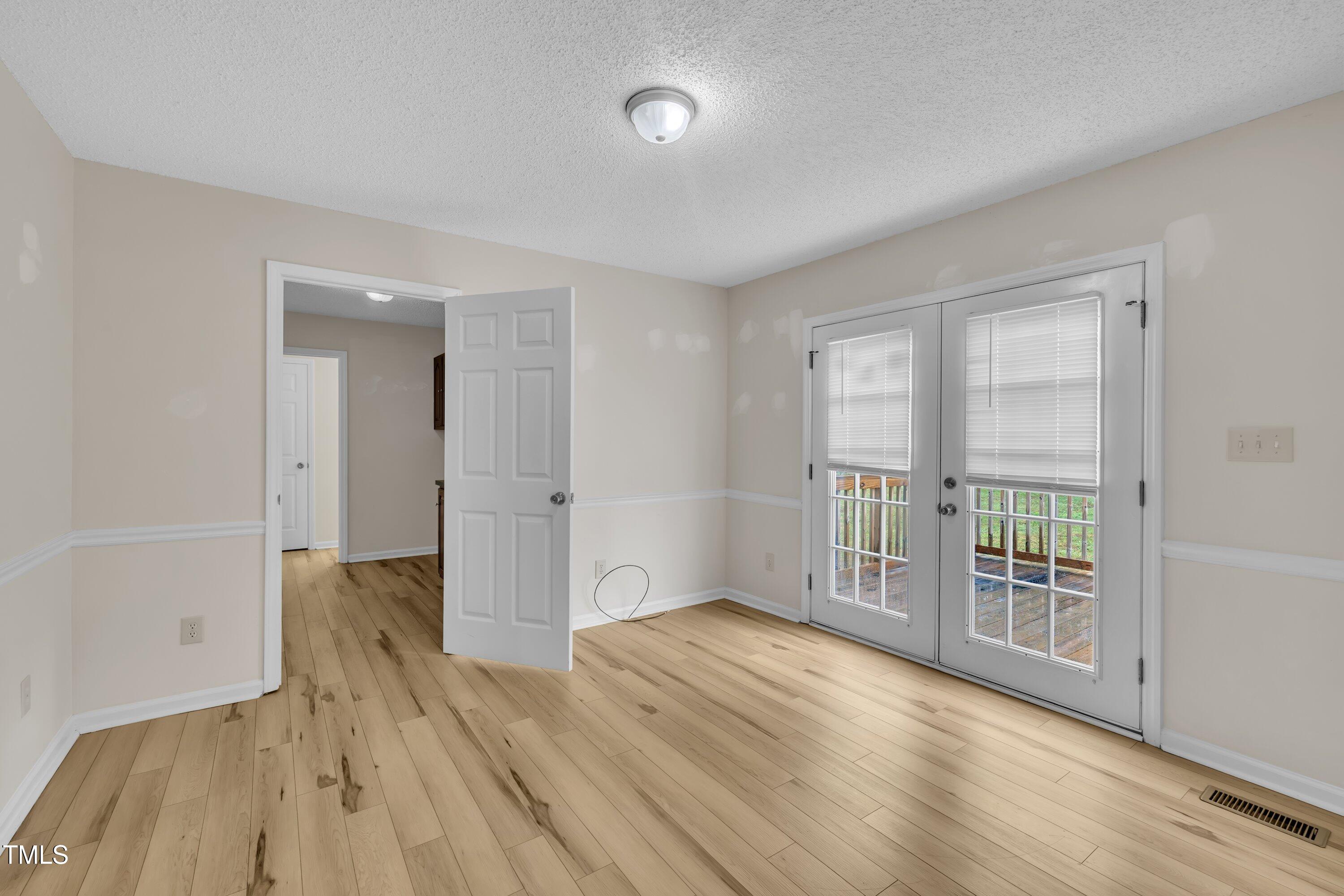 397 Meadow Road Kenly, NC 27542 - Photo 24 of 53 wooden floor in an empty room with a window