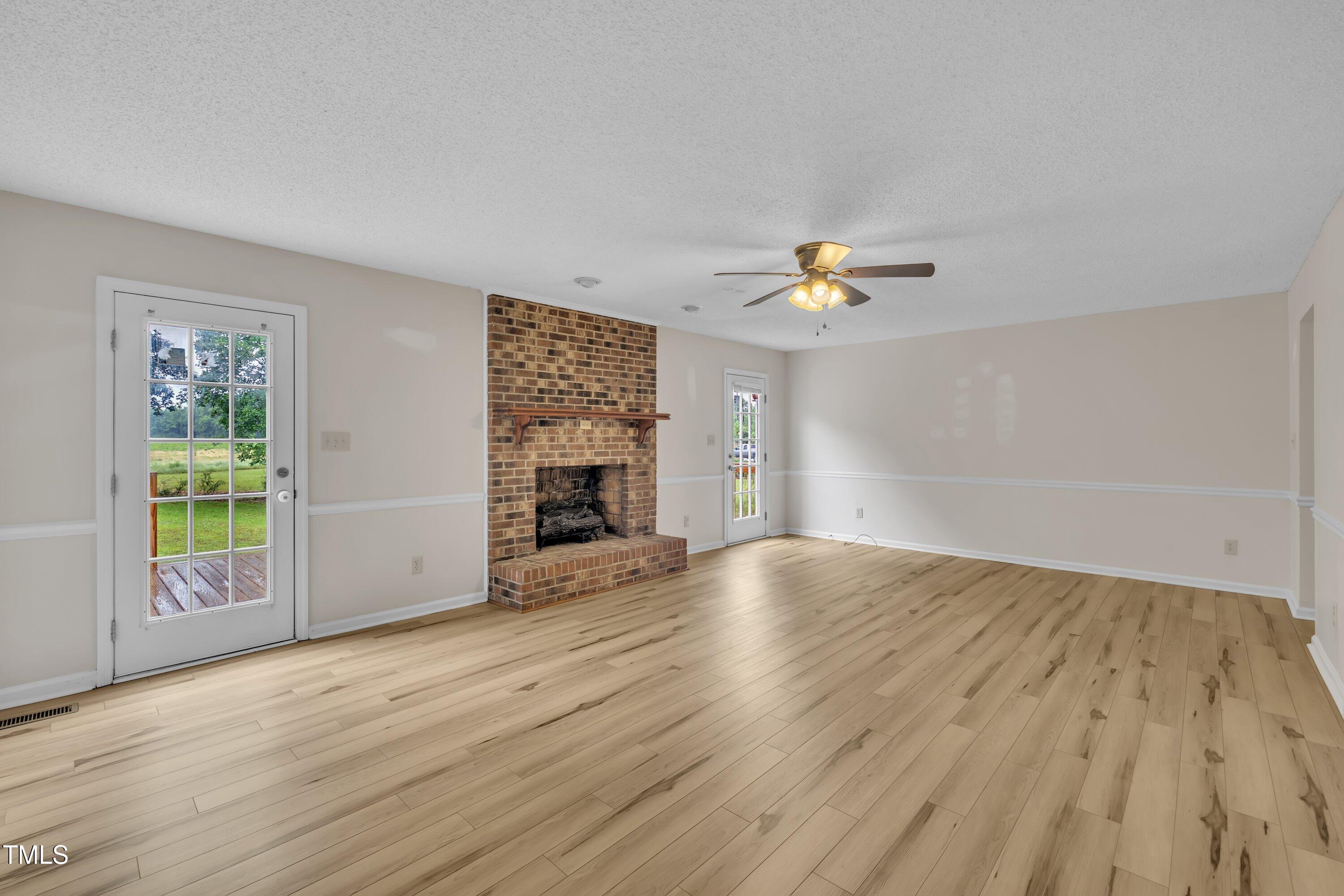 397 Meadow Road Kenly, NC 27542 - Photo 26 of 53 an empty room with windows and fireplace