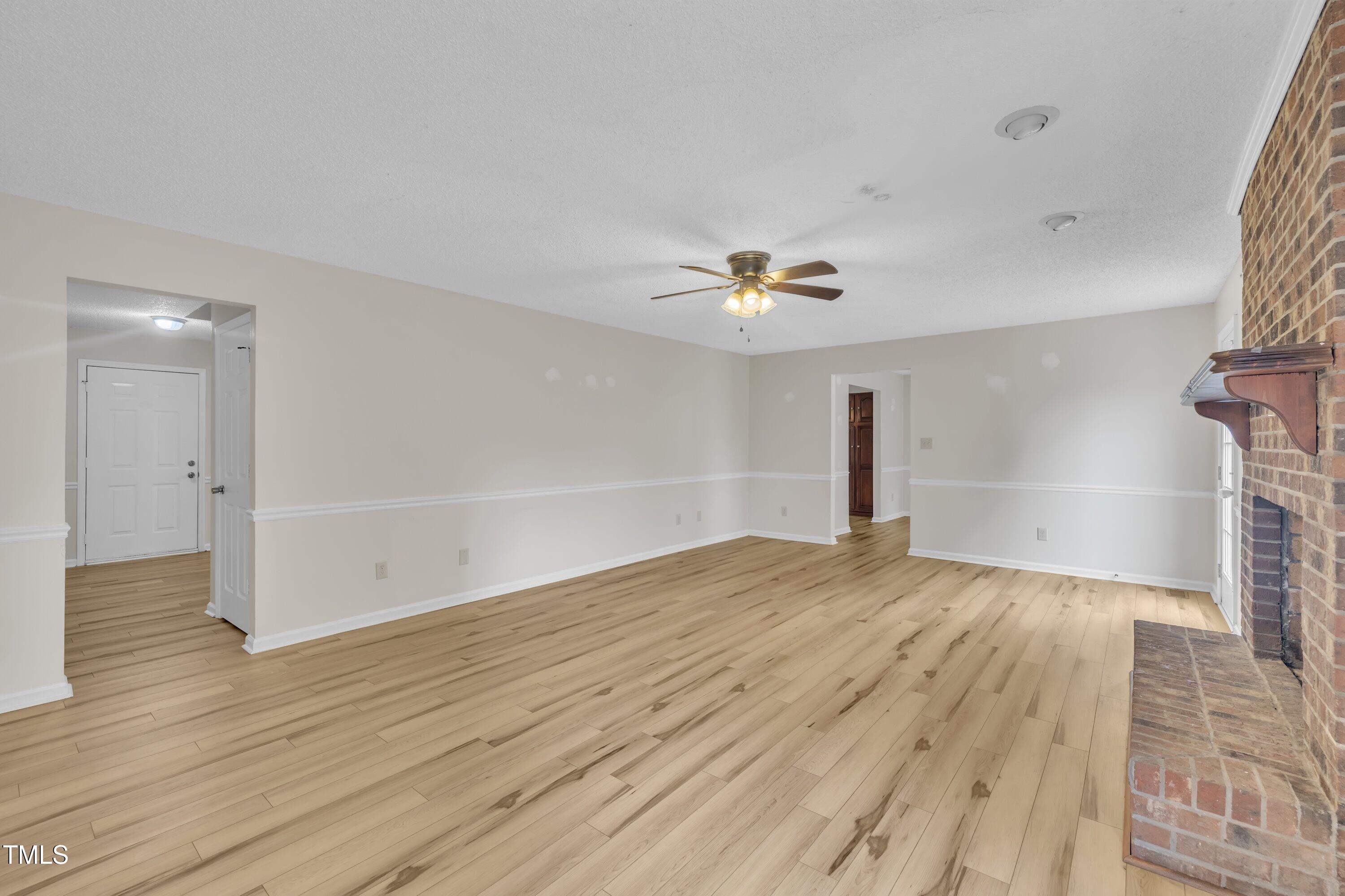 397 Meadow Road Kenly, NC 27542 - Photo 28 of 53 a view of empty room with wooden floor and fan