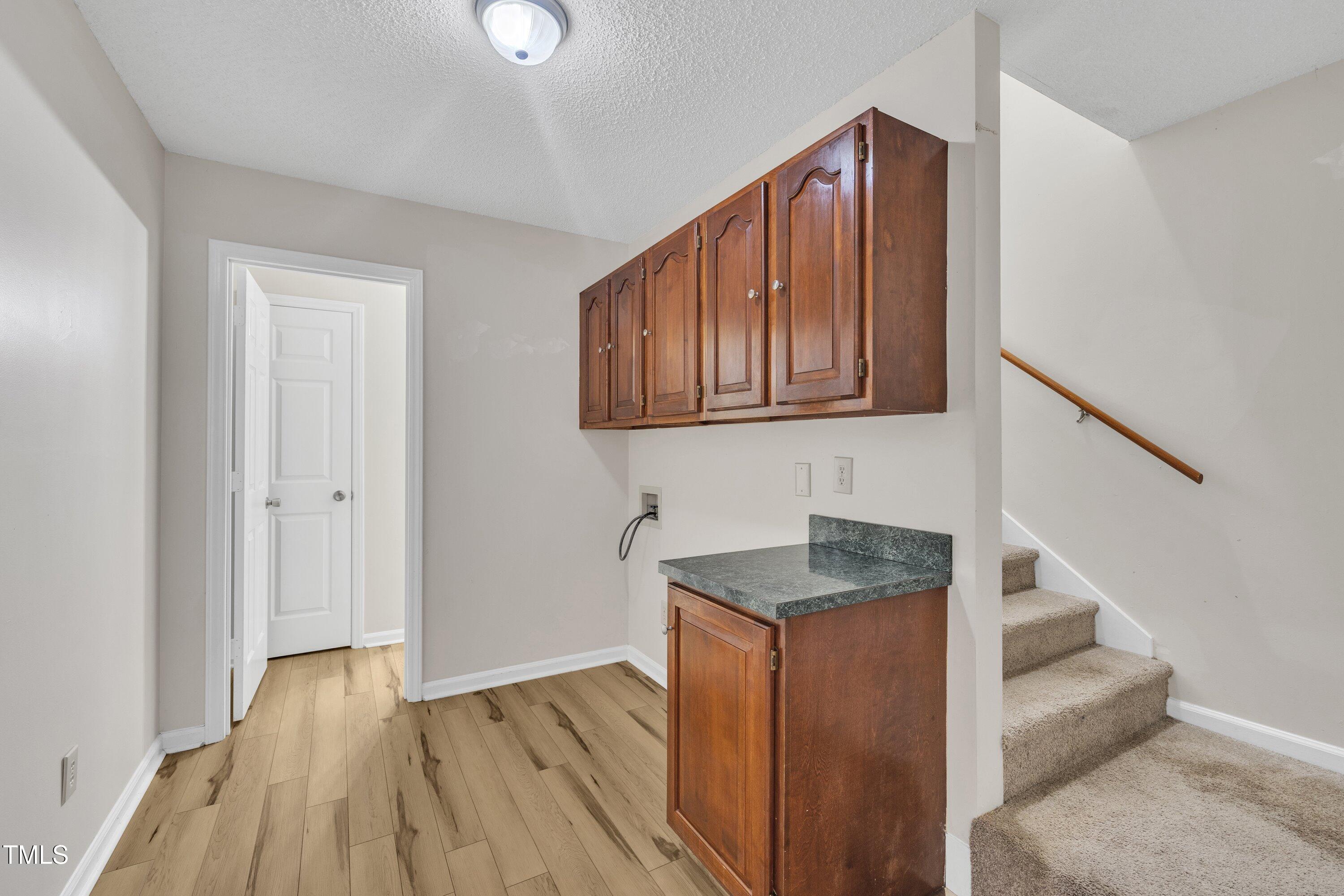 397 Meadow Road Kenly, NC 27542 - Photo 30 of 53 a hallway with granite countertop wooden floors and granite countertops