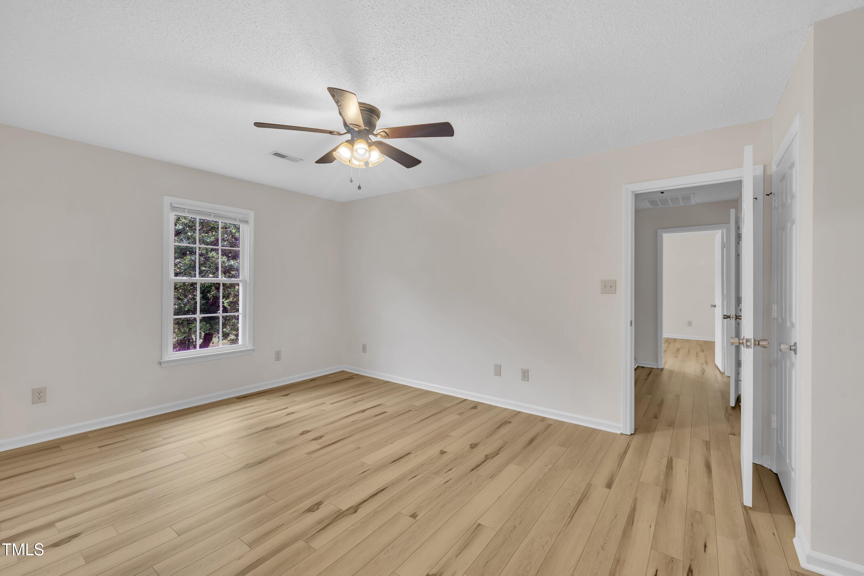 397 Meadow Road Kenly, NC 27542 - Photo 37 of 53 a view of empty room with wooden floor and fan