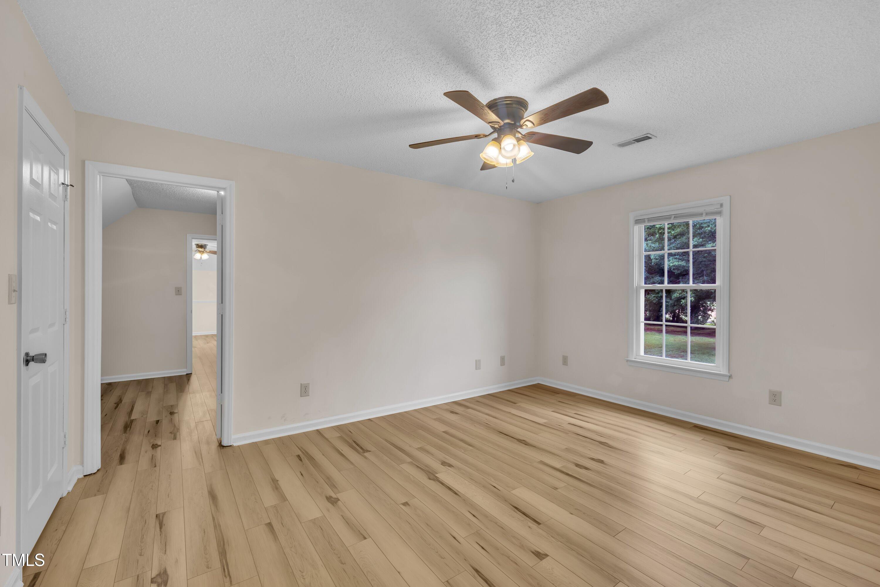 397 Meadow Road Kenly, NC 27542 - Photo 38 of 53 a view of empty room with wooden floor and fan
