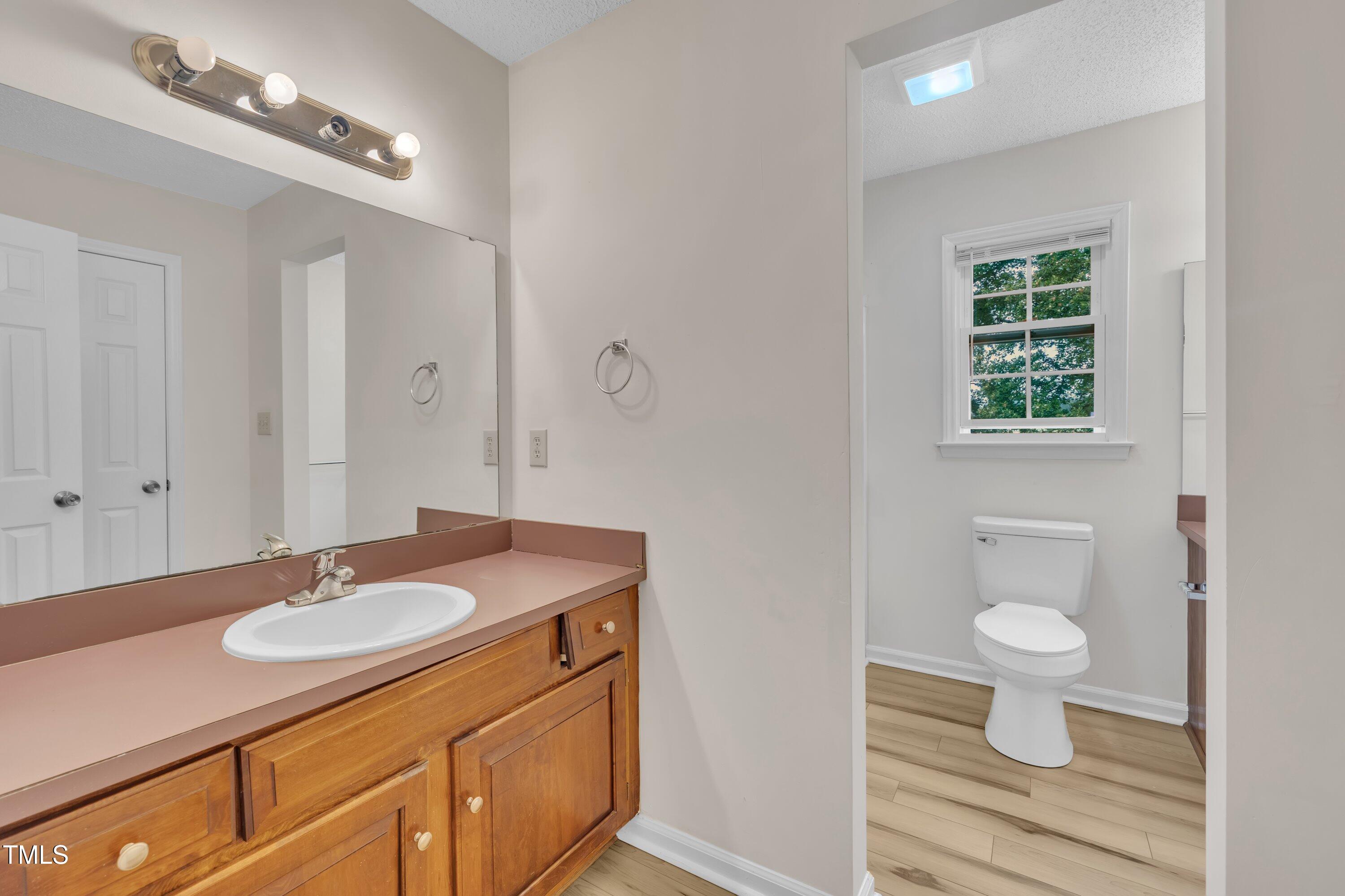 397 Meadow Road Kenly, NC 27542 - Photo 39 of 53 a bathroom with a toilet sink and mirror