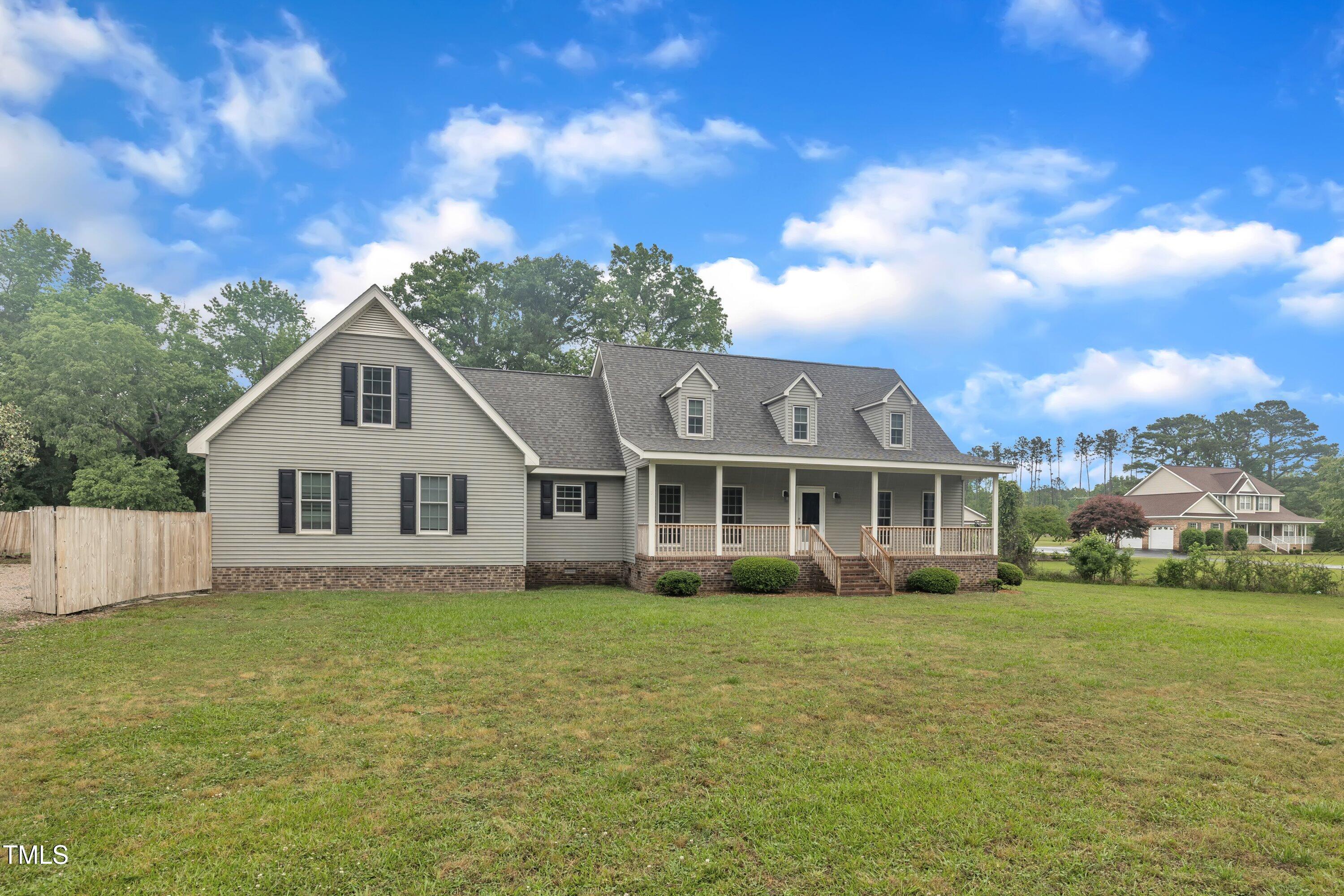 397 Meadow Road Kenly, NC 27542 - Photo 4 of 53 a view of a house with a big yard and large trees