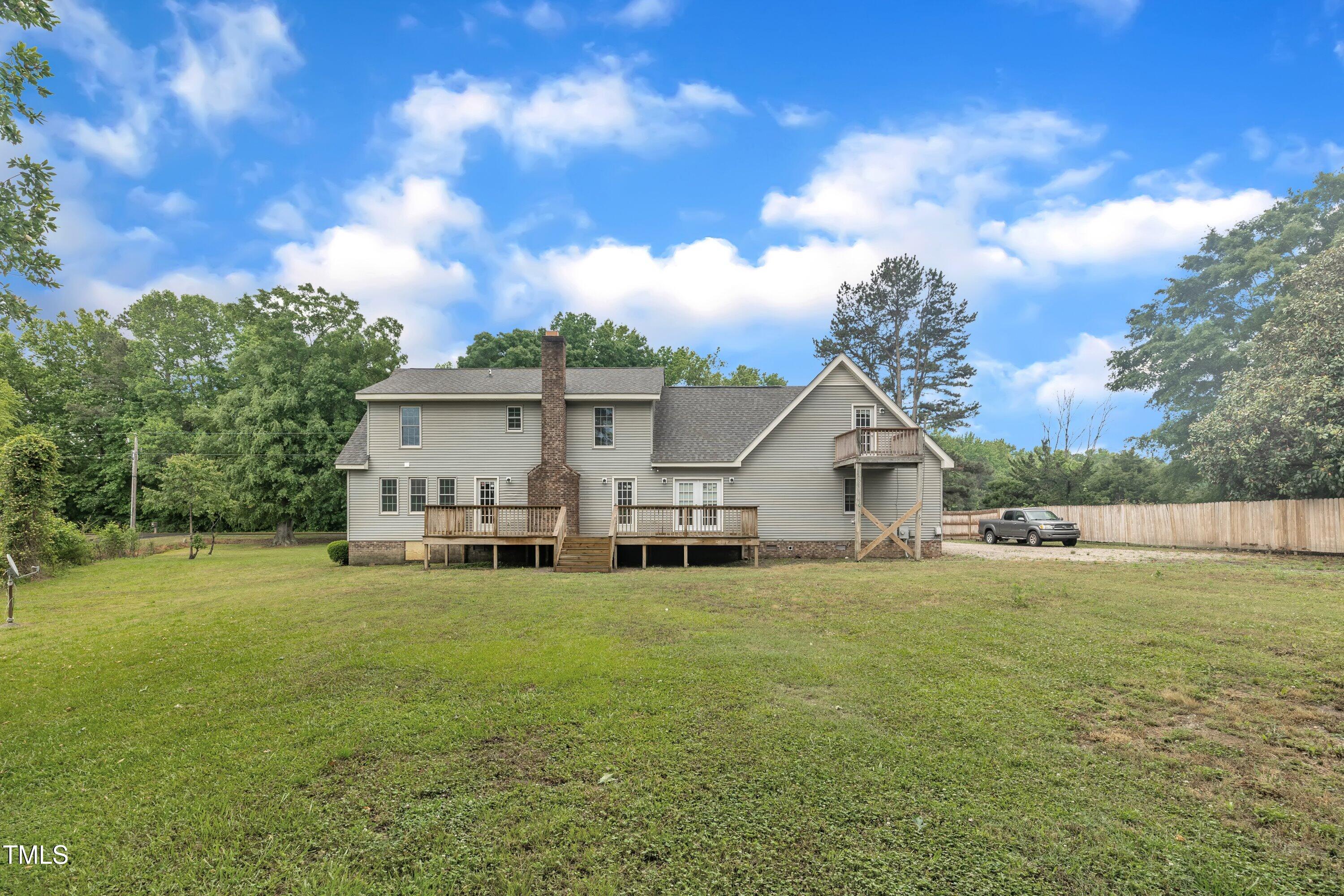 397 Meadow Road Kenly, NC 27542 - Photo 51 of 53 a view of a house with a big yard and a large tree