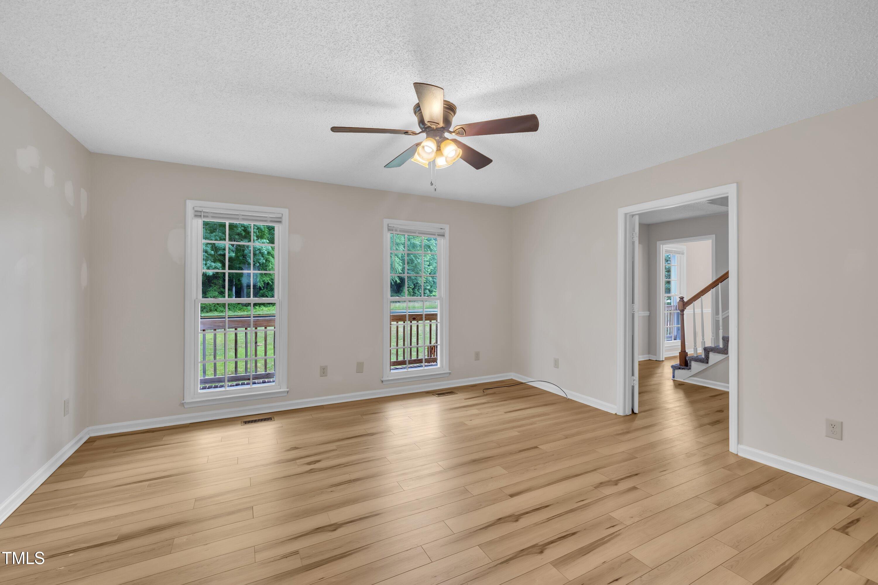 397 Meadow Road Kenly, NC 27542 - Photo 9 of 53 a view of an empty room with window and wooden floor