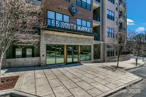 a view of a brick building next to a yard